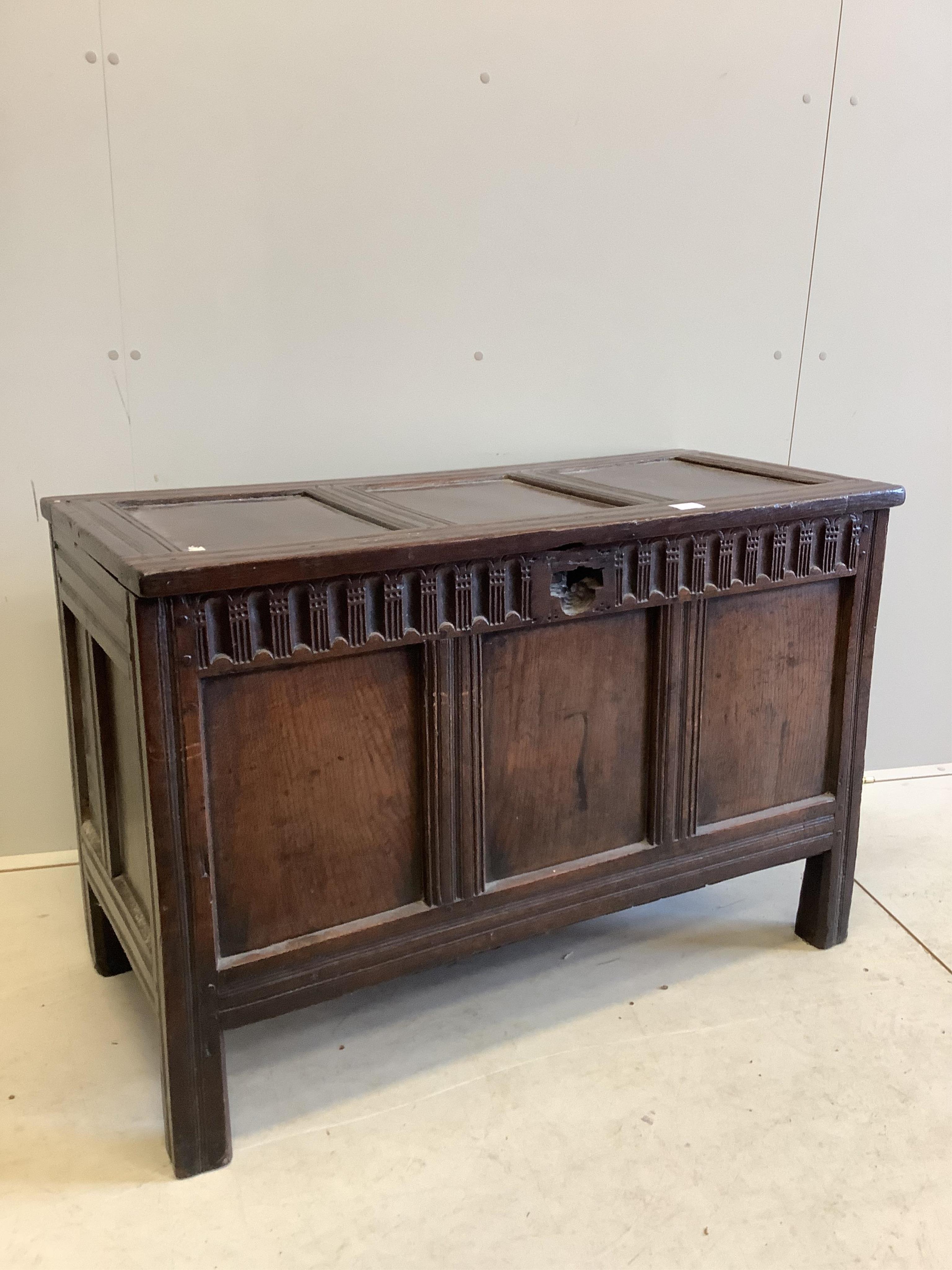 A 17th century panelled oak coffer, (damage to lock), width 111cm, depth 54cm, height 75cm. Condition - poor